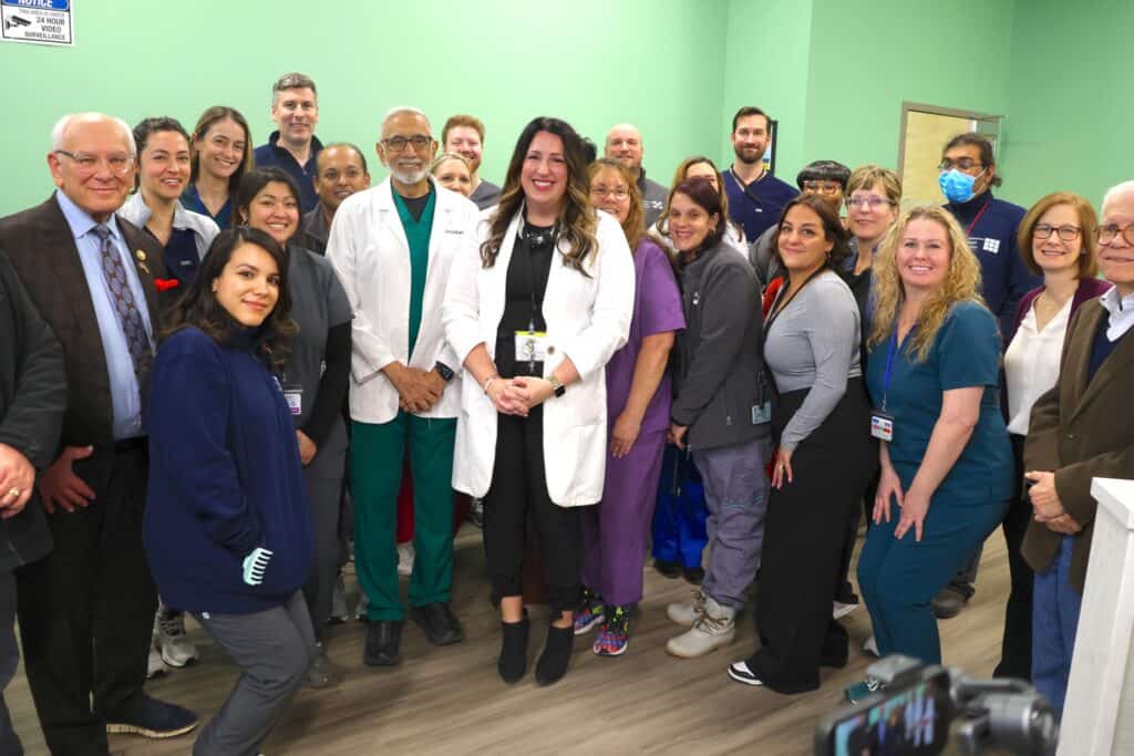 A group of people posing for a photo in a medical office.